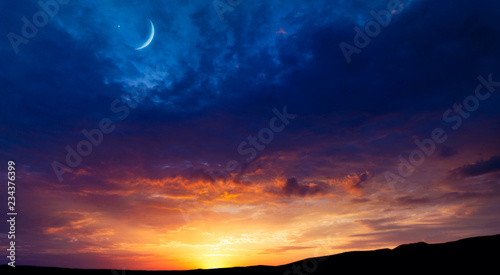 Fototapeta Naklejka Na Ścianę i Meble -   Crescent moon with beautiful sunset background . Generous Ramadan  .  Light from sky . Religion background .Crescent moon with beautiful sunset background .  Light from sky . beautiful sky 