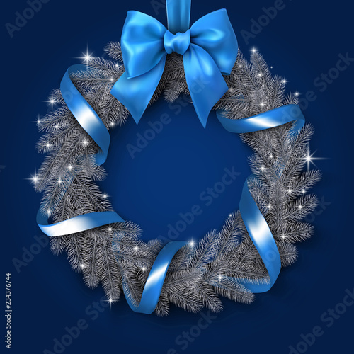 Christmas and New Year card with Christmas wreath with blue ribbon and bow.