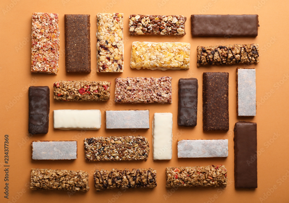 Flat lay composition with protein bars on color background Flat lay composition with protein bars on color background