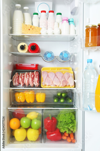 Wallpaper Mural Open refrigerator with many different products, closeup Torontodigital.ca