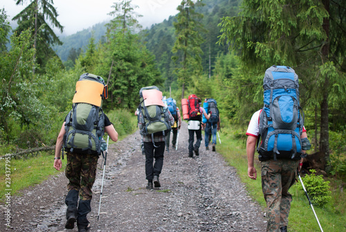 Group of tourists went to mountain forest for extreme advnture photo