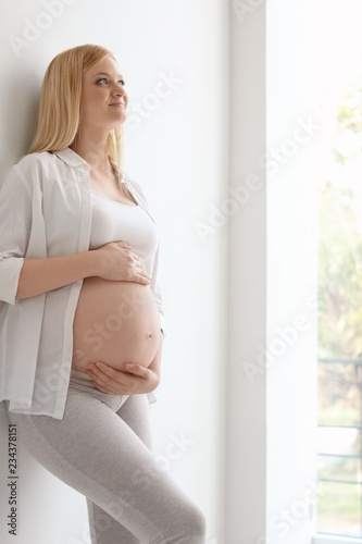 Portrait of beautiful pregnant woman near light wall Free Download Portrait of beautiful pregnant woman near light wall - GFXLoad