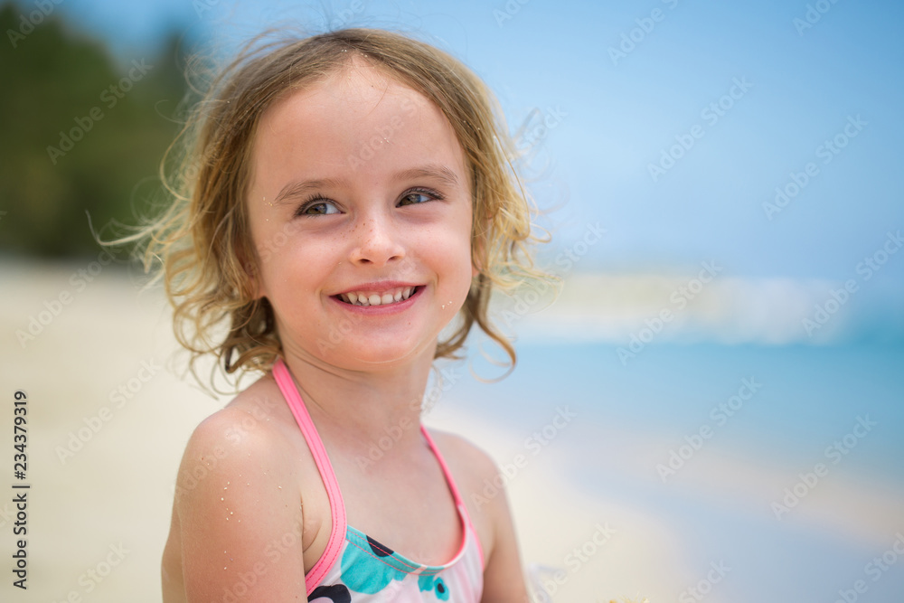 Portrait of adorable little girl at beach during summer vacation Portrait of adorable little girl at beach during summer vacation