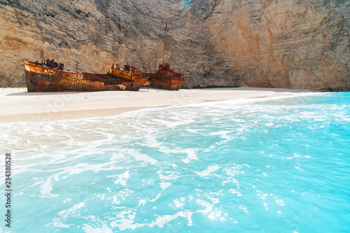 Navagio Shipwreak beach with rusty ship and clear blue water of Zakinthos island, Greece photo