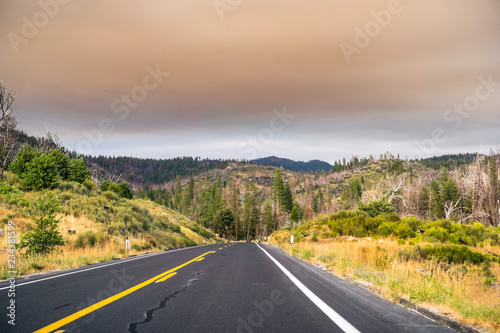 Driving through Yosemite National Park; filtered light due to the smoke coming from Ferguson Fire covering the sky, Caifornia photo