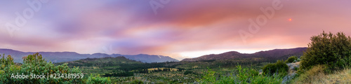 View towards Ferguson Fire burning just outside Yosemite National Park; smoke clouds covering the sun; California photo