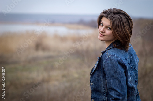Photography Girl turns around. Closeup, blurred background, overcast