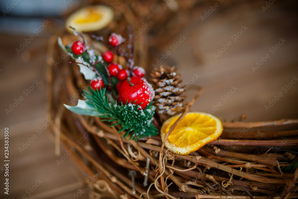 nest of vine with the decor. Christmas wreath. Berries and candied fruits on wreath.