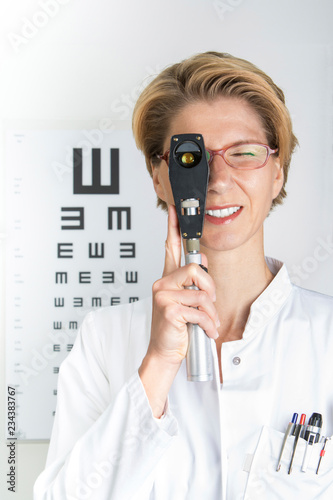 Young eye doctor with ophthalmoscope, W34, Munich, Bavaria, Germany photo