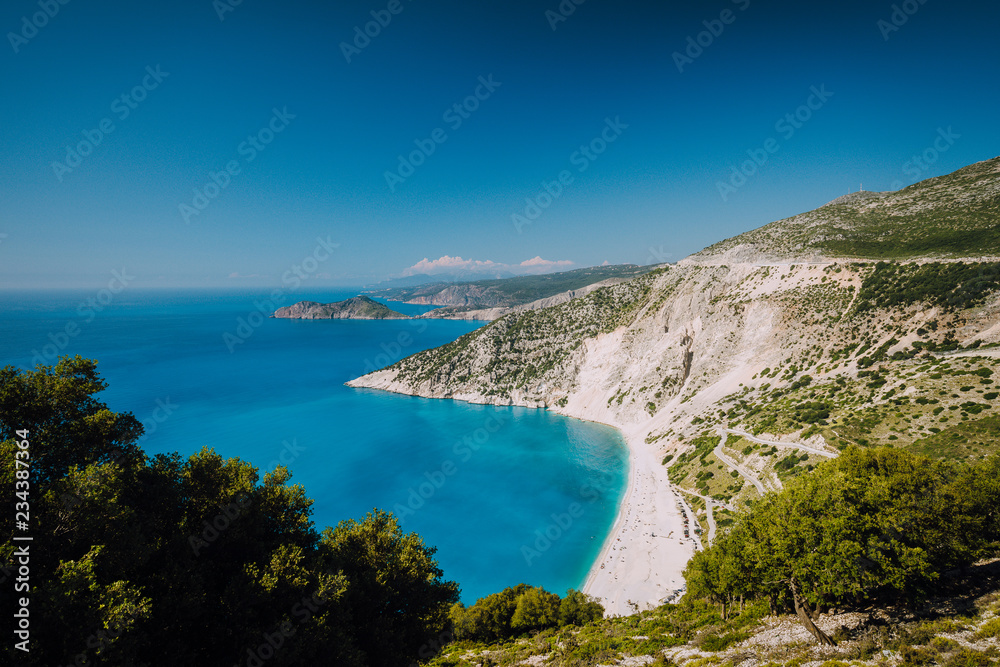 Beautiful view of Myrtos beach in high tourist summer season. Myrtos is one of the famous beaches in the world and the Mediterranean sea located in Kefalonia island, Greece, Europe