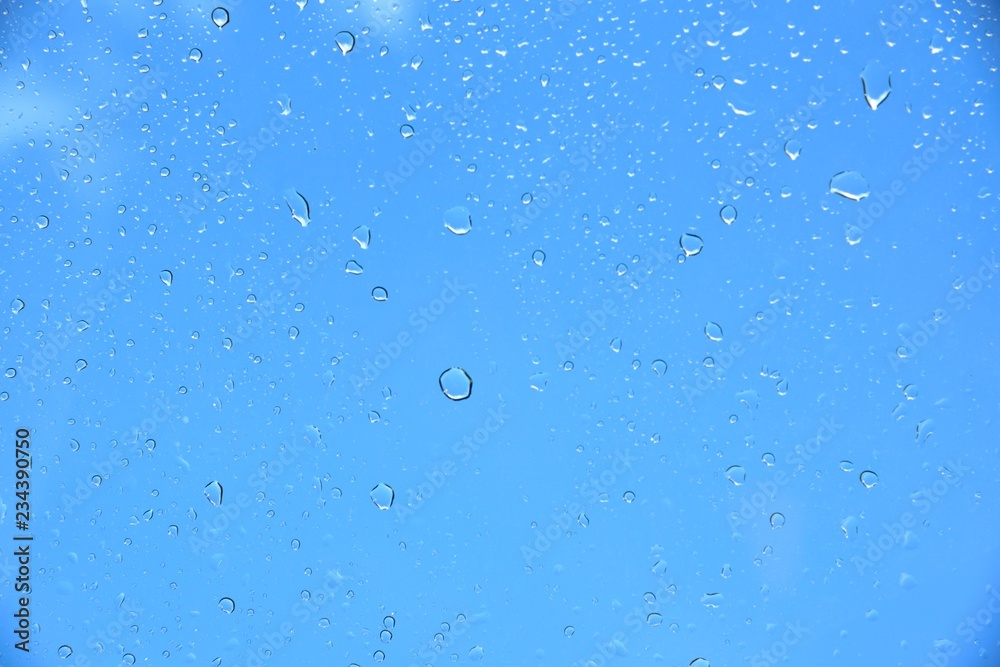 drop water on glass on blue sky background 