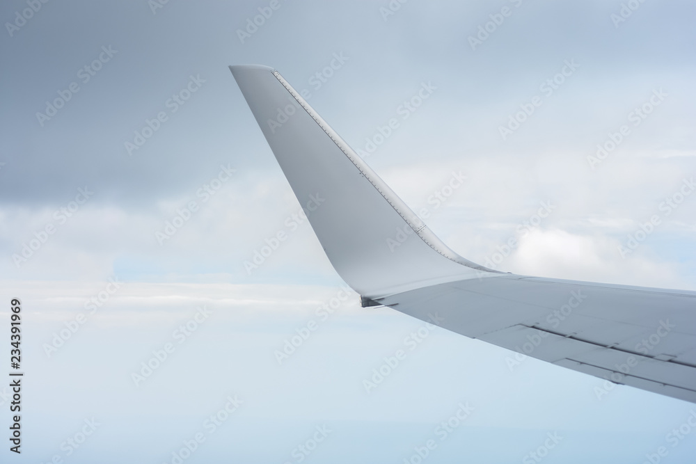 Obraz premium KUALA LUMPUR, MALAYSIA-OCTOBER 30 2018:The wing of Malaysia Airline MAS fleet views from a window during flight time over the blue sky