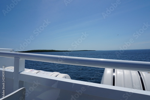View from side of boat with lake and horizon in background © R MACKAY