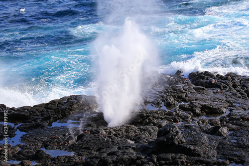Water bursts through blowhole on Espanola Island, Galapagos National park, Ecuador. photo
