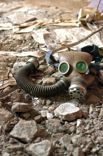 gas mask lies on the broken stone floor