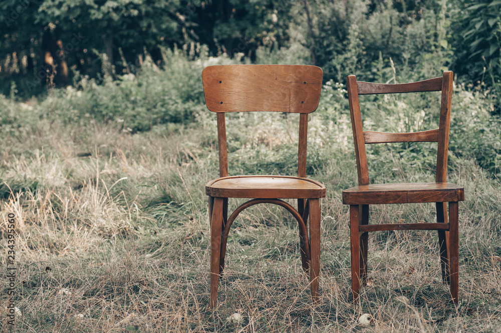 Wooden chair, wooden chair twin, Pair old wooden chair outdoors. Around the lush grass, The environment offers privacy. Wooden chair, wooden chair twin, Pair old wooden chair outdoors. Around the lush grass, The environment offers privacy.