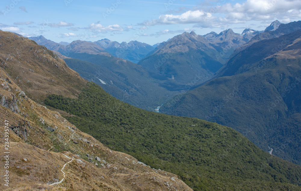 A view at hills and mountains from the Conical Hill at the Harris Saddle at the Routeburn Great Walk, New Zealand