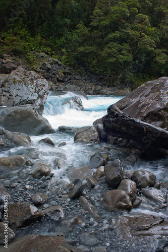 A stream with rocks at Falls Creek on the Milford Sound Highway in Fiordland in New Zealand
