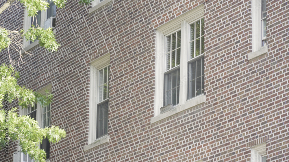 Naklejka premium Typical exterior establishing photo outside brick apartment building in city. Brooklyn style setting day time DX