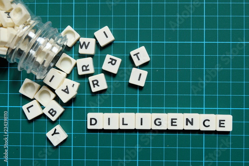 Diligence word made of square letter word on green square mat background.