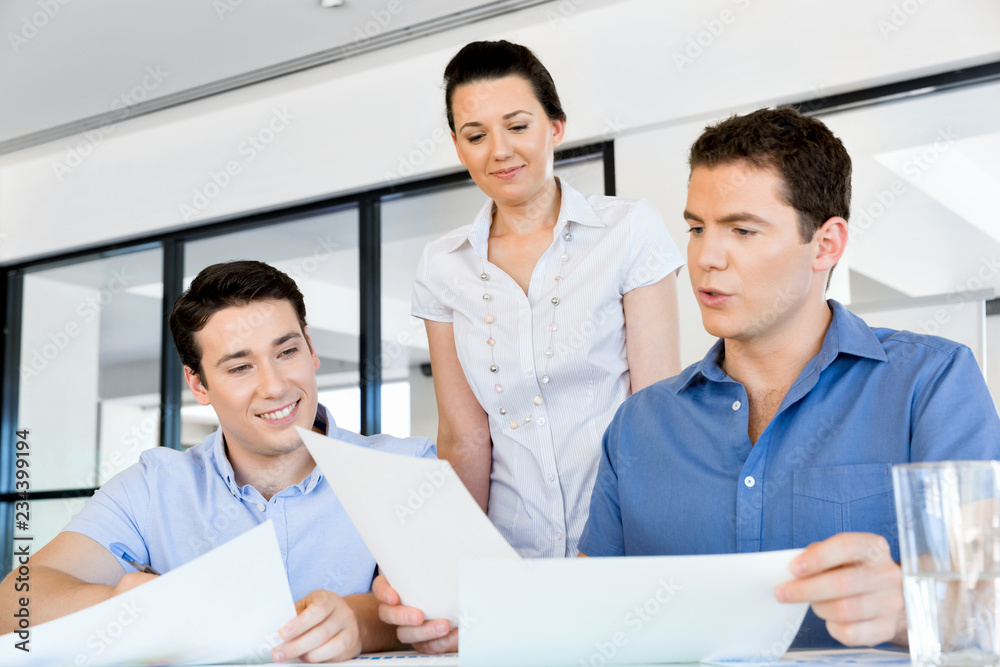 Fototapeta premium Group of happy young business people in a meeting
