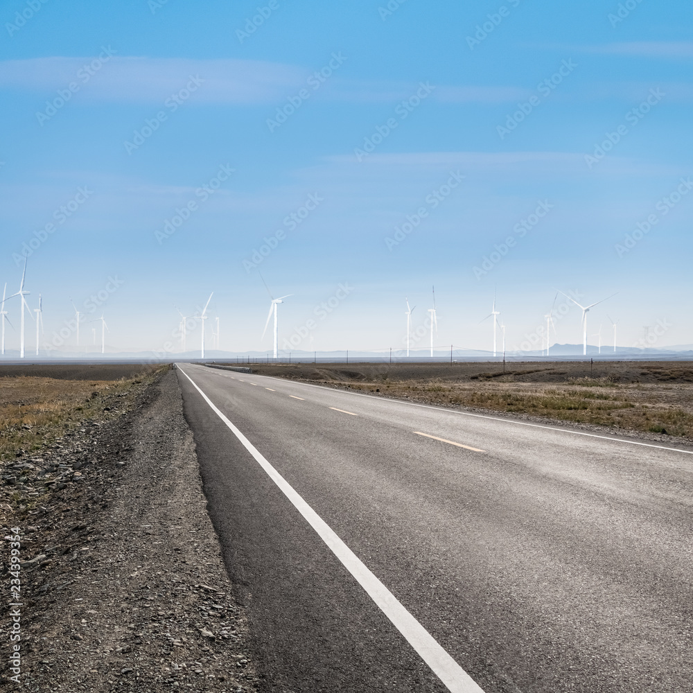 Fototapeta premium road on wilderness and wind power farm