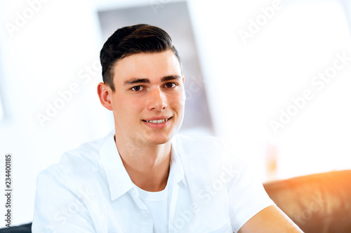Portrait of a smart young man indoors photo