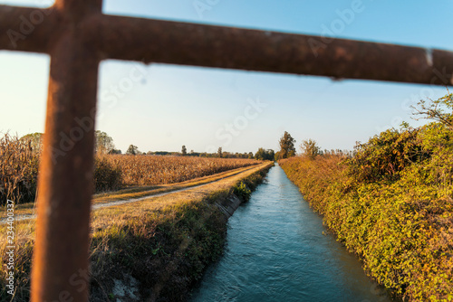 Bridge over an irrigation channel of the Lomellina at sunset