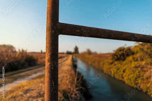 Bridge over an irrigation channel of the Lomellina at sunset