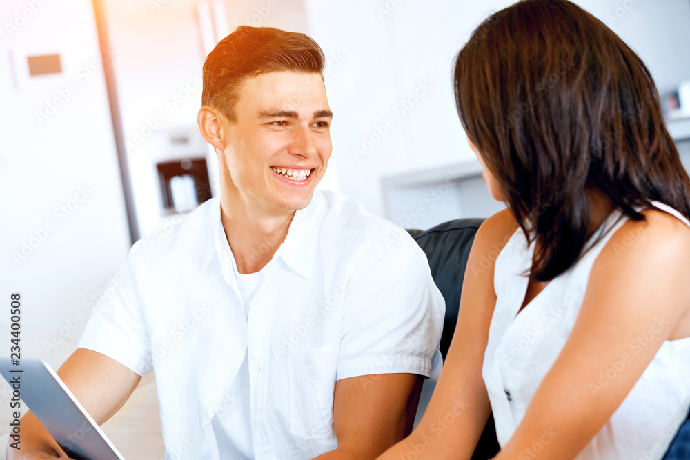 Fototapeta premium Happy modern couple working on laptop at home