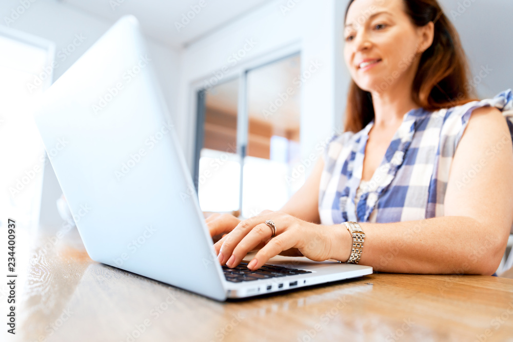 Mature beautiful woman working on her laptop Mature beautiful woman working on her laptop