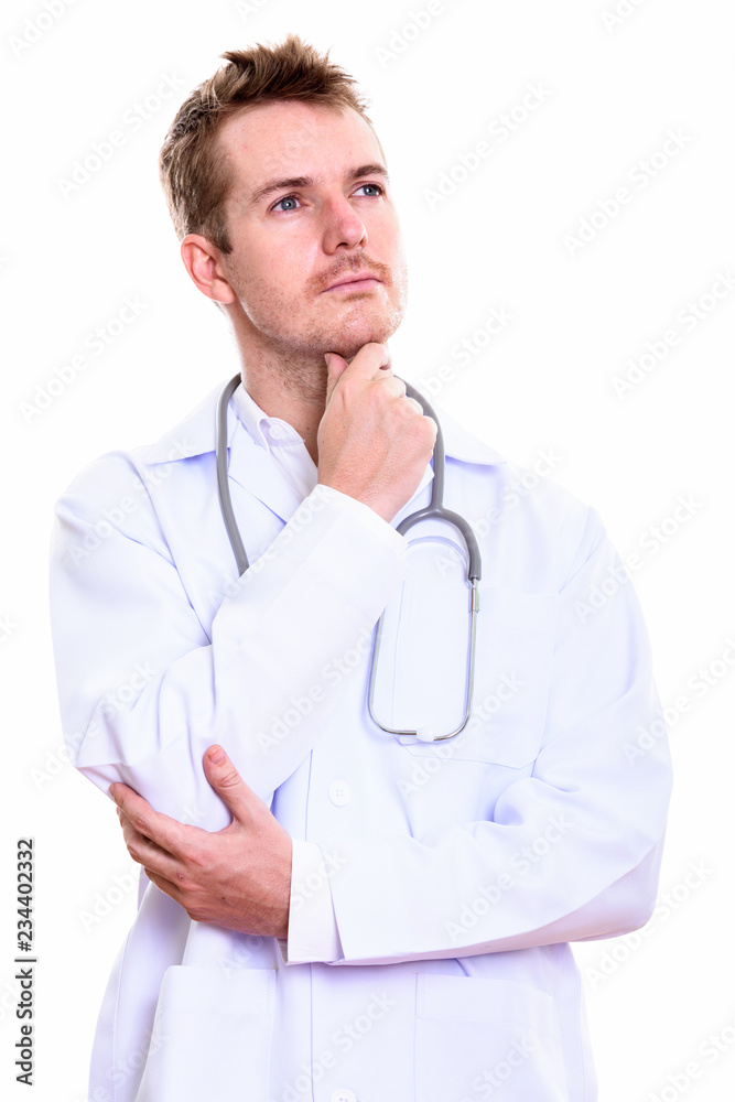 Studio shot of man doctor thinking while looking up Studio shot of man doctor thinking while looking up