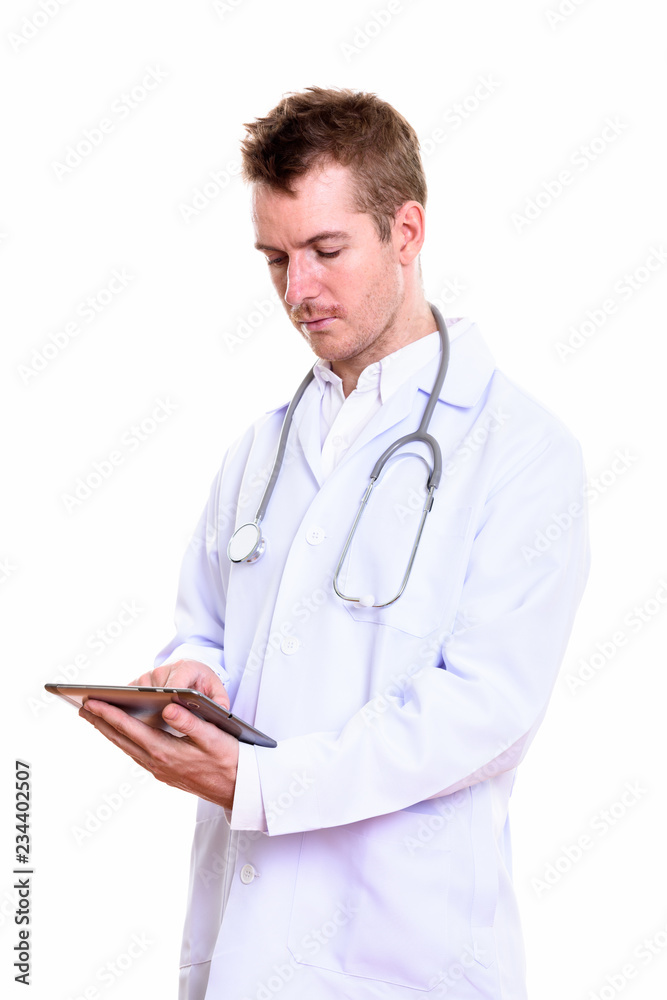 Studio shot of man doctor using digital tablet Studio shot of man doctor using digital tablet