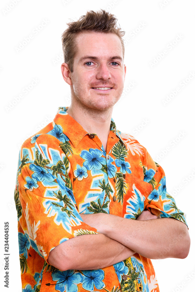 Studio shot of happy man smiling with arms crossed
