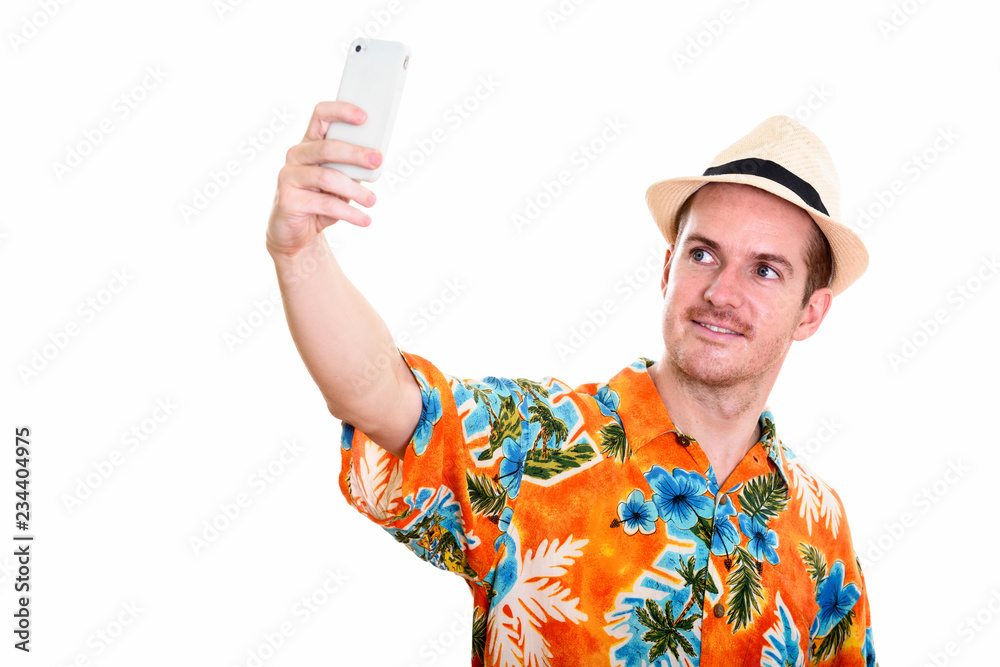 Studio shot of happy man smiling while taking selfie picture wit Studio shot of happy man smiling while taking selfie picture wit