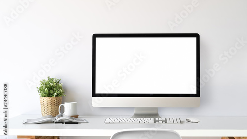 Workspace with blank screen computer on a white table