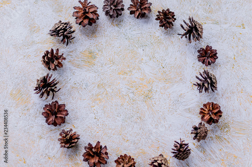 round of brown fir cones on a white background on New Year's Eve. Christmas advent calendar.Pine cones for decoration at modern house. Interior concept.Christmas wreath concept.Copy space