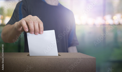 Bild auf Leinwand Hand holding ballot paper for election vote at place election background