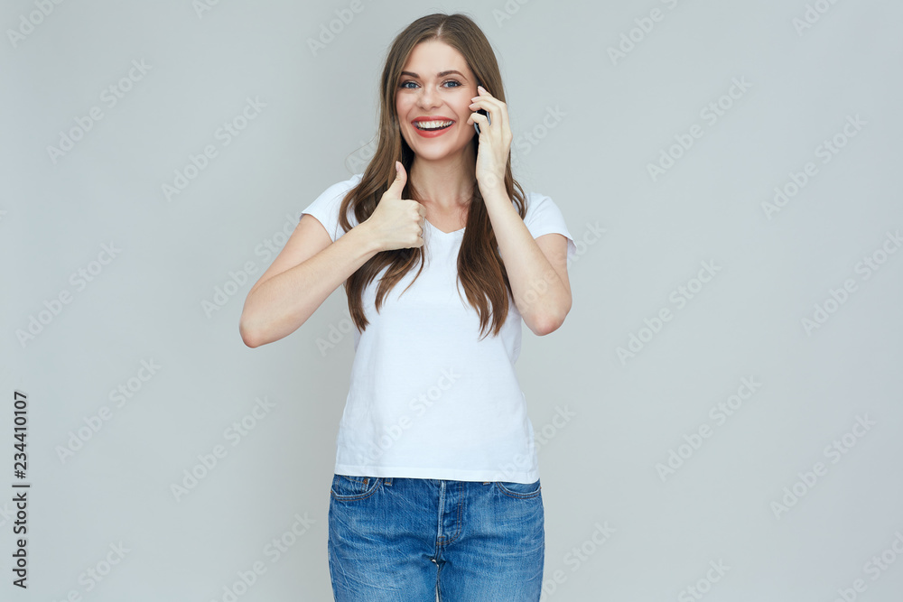 Smiling woman talking on cell phone doing thumb up. Smiling woman talking on cell phone doing thumb up.