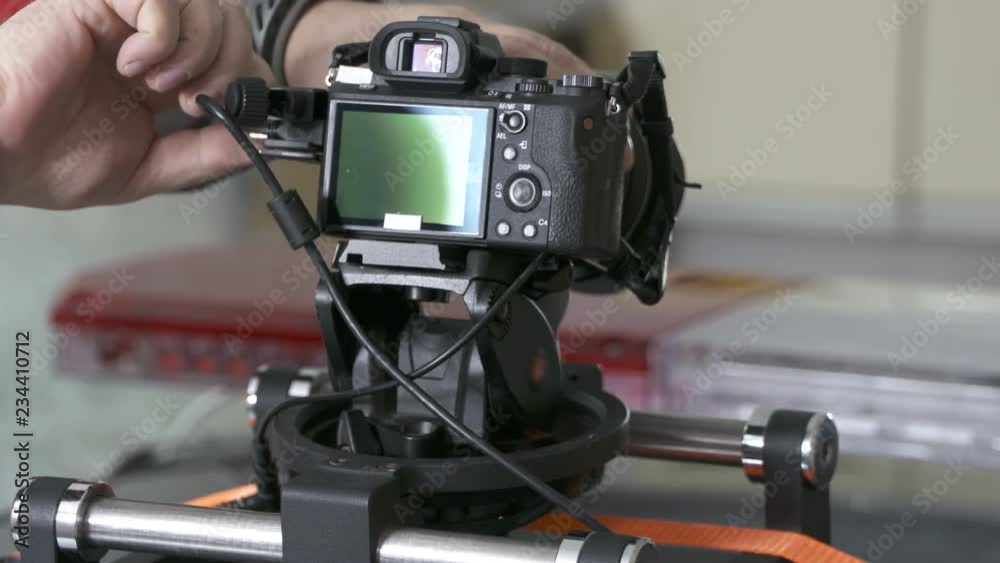 DSLR car suction cup camera mount for shooting on a moving vehicle. Mounting professional video equipment on top of police car. DSLR car suction cup camera mount for shooting on a moving vehicle. Mounting professional video equipment on top of police car.
