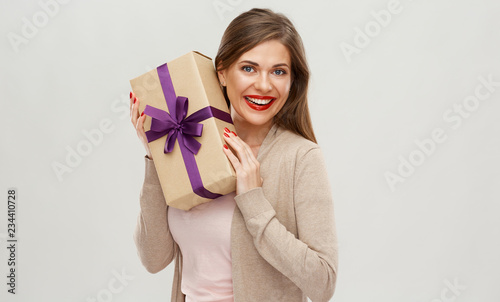 Happy girl holding gift. Isolated portrait