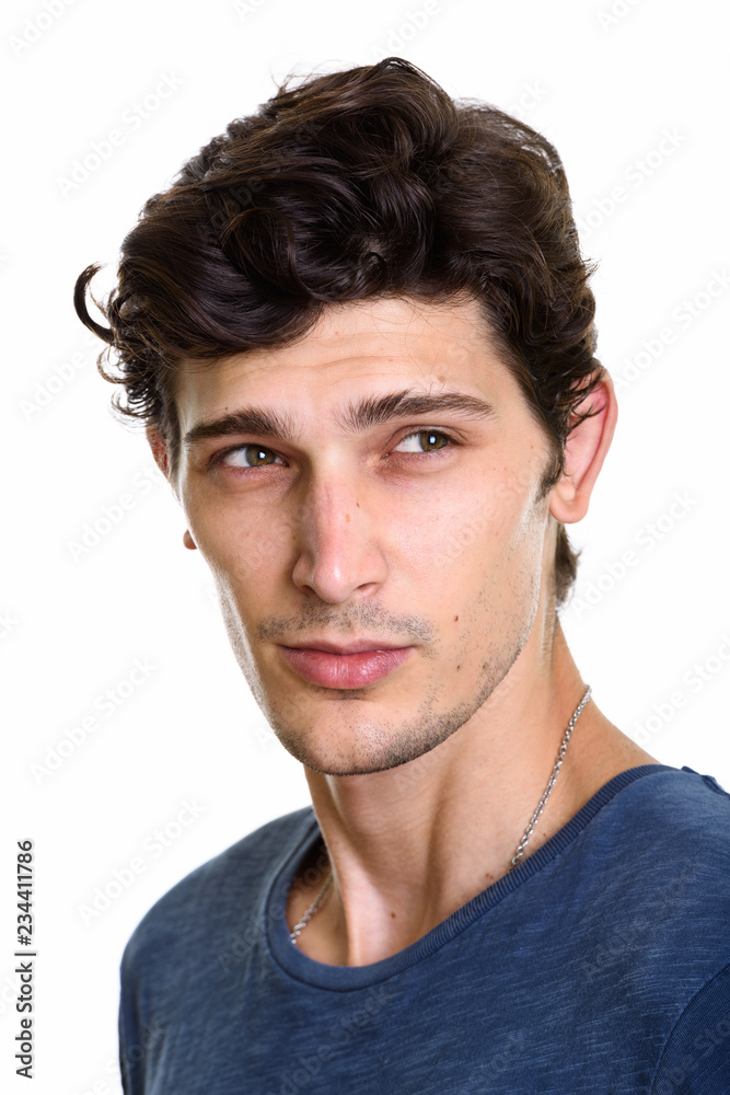 Face of young handsome man thinking while looking at distance Face of young handsome man thinking while looking at distance