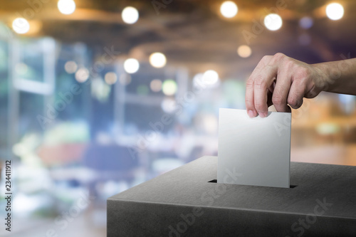 Tablou pe pânză Hand holding ballot paper for election vote at place election background
