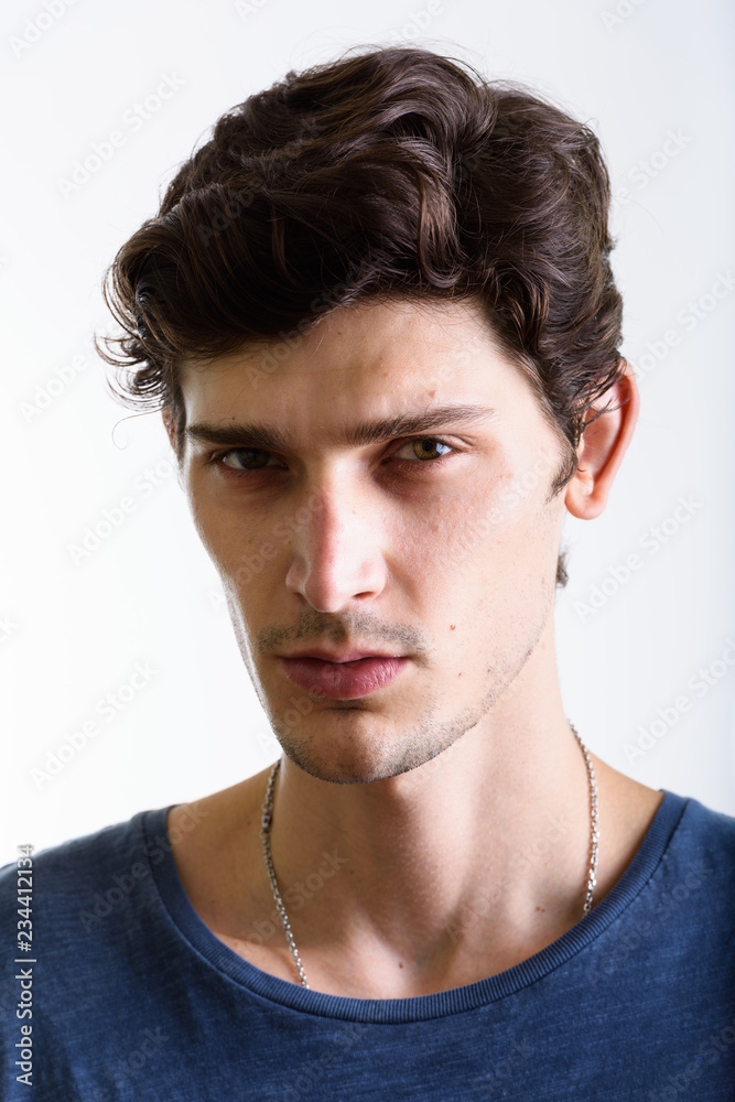 Face of young handsome Brazilian man looking at camera Face of young handsome Brazilian man looking at camera