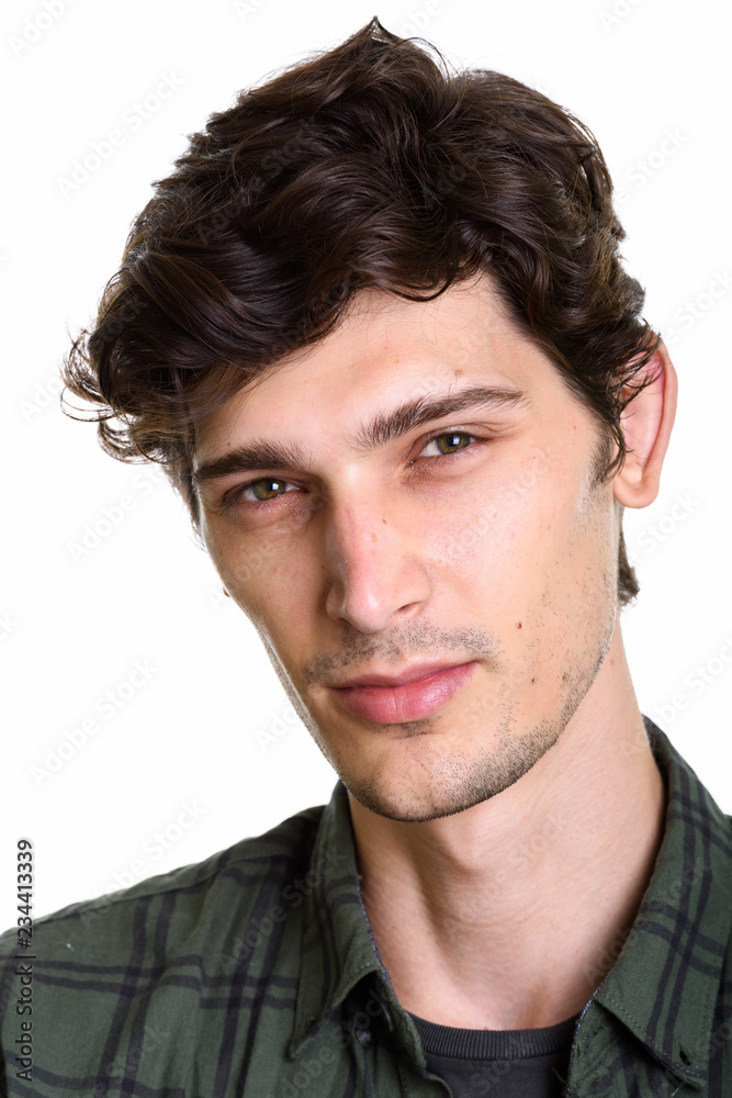 Naklejka premium Face of young handsome Hispanic man looking at camera