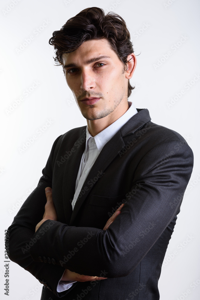 Studio shot of young handsome businessman with arms crossed Studio shot of young handsome businessman with arms crossed