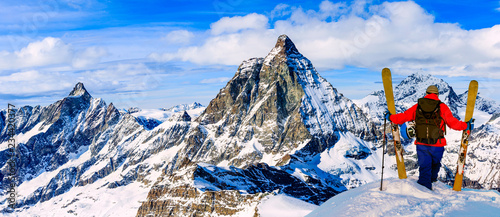 Ski with amazing view of swiss famous mountains in beautiful winter snow Mt Fort. The skituring, backcountry skiing in fresh powder snow. photo