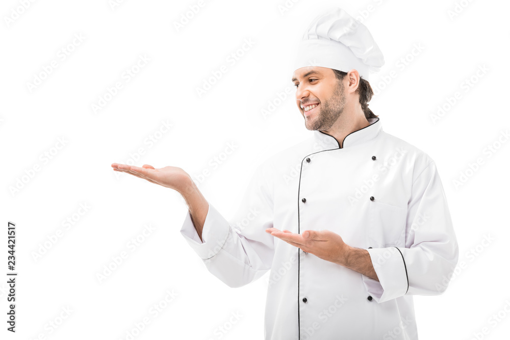 smiling young chef pointing at blank space isolated on white smiling young chef pointing at blank space isolated on white