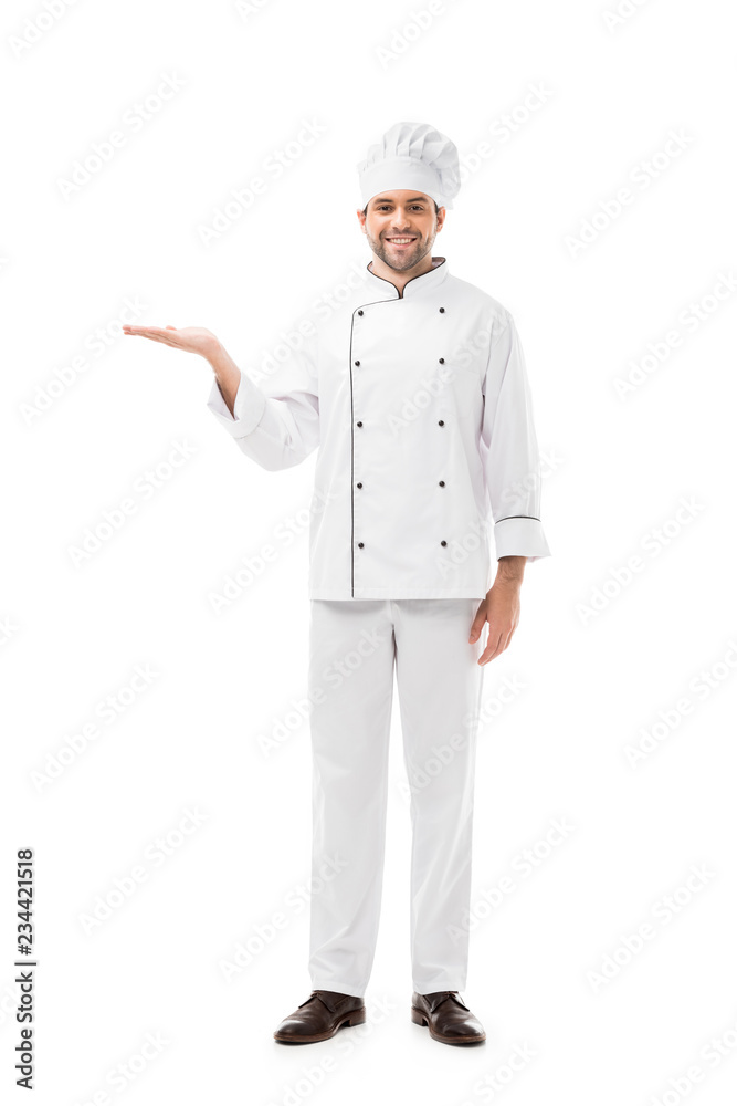 smiling young chef pointing at blank space and looking at camera isolated on white smiling young chef pointing at blank space and looking at camera isolated on white