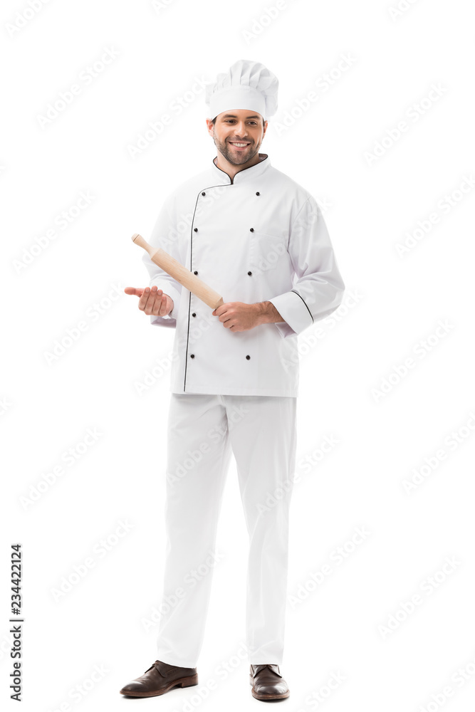 handsome young chef holding rolling pin isolated on white
